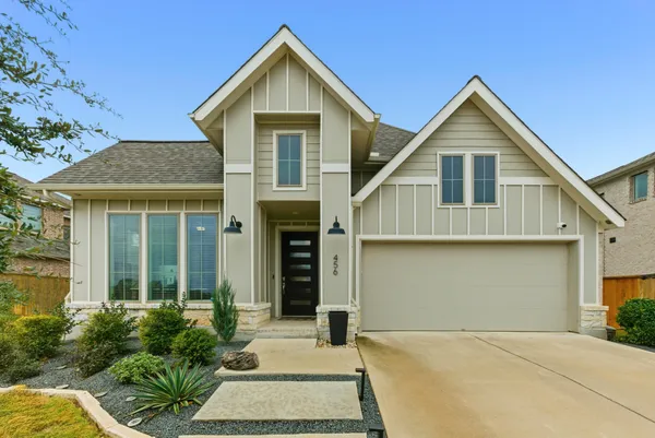 a view of a house with a yard and sitting area