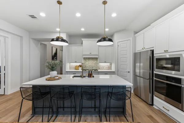 a kitchen with a table and chairs in it