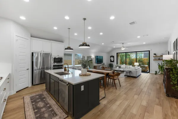 a kitchen with sink stove and refrigerator