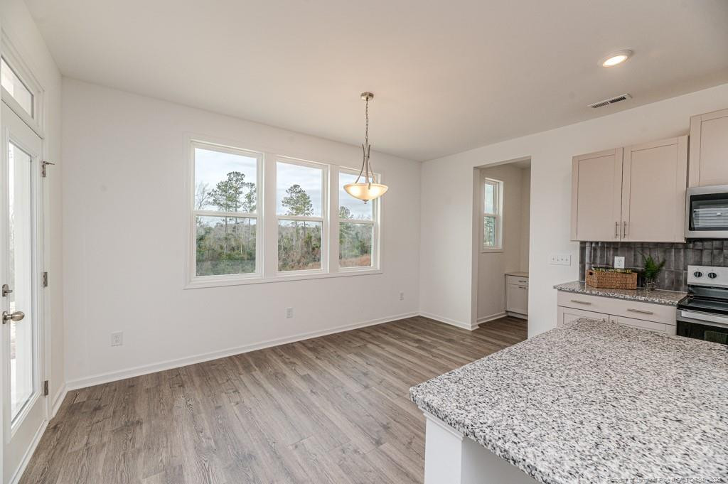 175 Marlborough Street Raeford, NC 28376 - Photo 13 of 22 a kitchen with granite countertop a stove a sink and a refrigerator