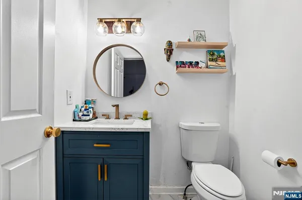 a bathroom with a sink a toilet and a mirror