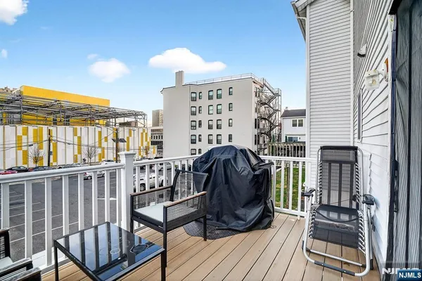 a view of a balcony with a potted plant and wooden floor