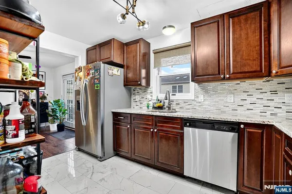 a kitchen with refrigerator and cabinets