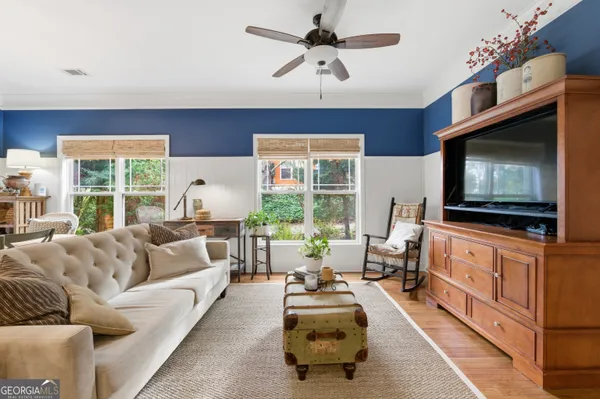 a living room with furniture and a flat screen tv