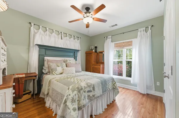 a bedroom with a bed and a ceiling fan