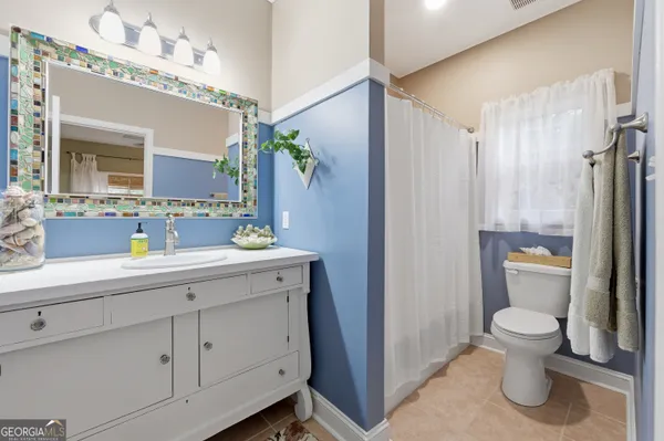 a spacious bathroom with a toilet sink and double vanity