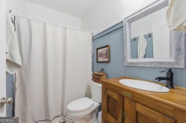 a bathroom with a sink a toilet and a mirror