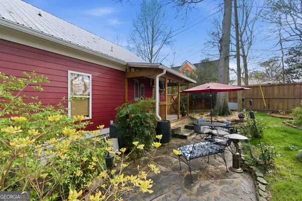 a backyard view with a seating space