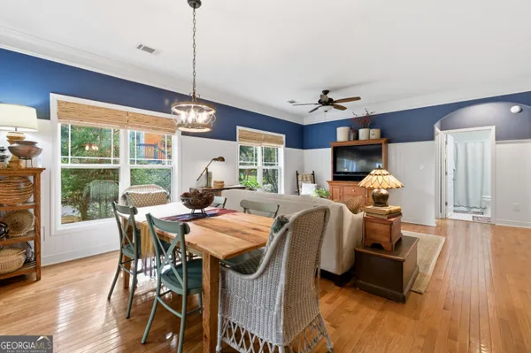 a dining room with furniture window and wooden floor