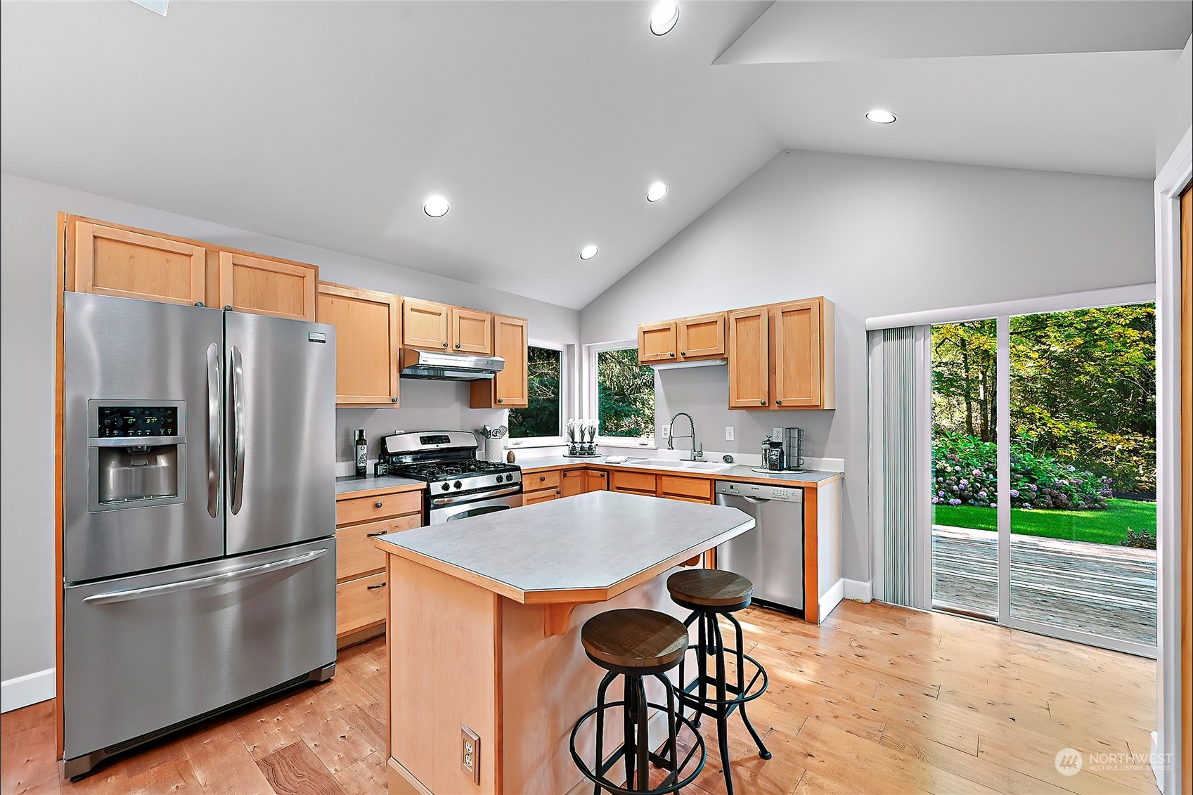 23026 30th Drive Southeast Bothell, WA 98021 - Photo 39 of 40 a kitchen with stainless steel appliances a refrigerator a stove a sink dishwasher a oven with white cabinets and wooden floor