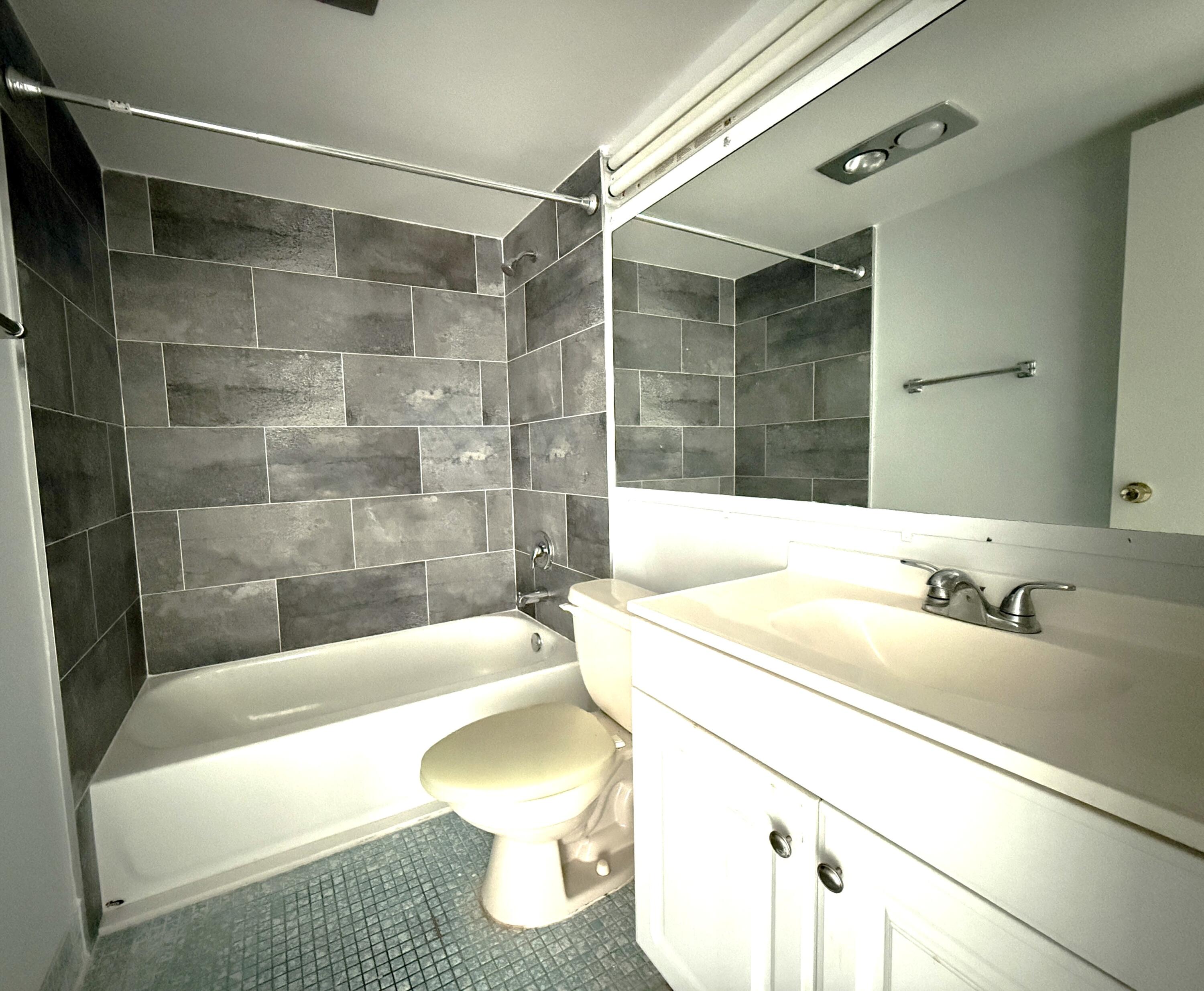 179 Northampton I West Palm Beach, FL 33417 - Photo 5 of 12 a bathroom with a sink a toilet and bathtub