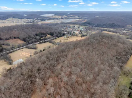 a view of a dry yard with wooden fence