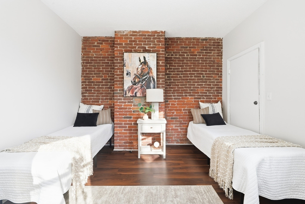 8 Humboldt Avenue, Unit 2 Boston, MA 02119 - Photo 15 of 39 a bed room with a bed and a couch