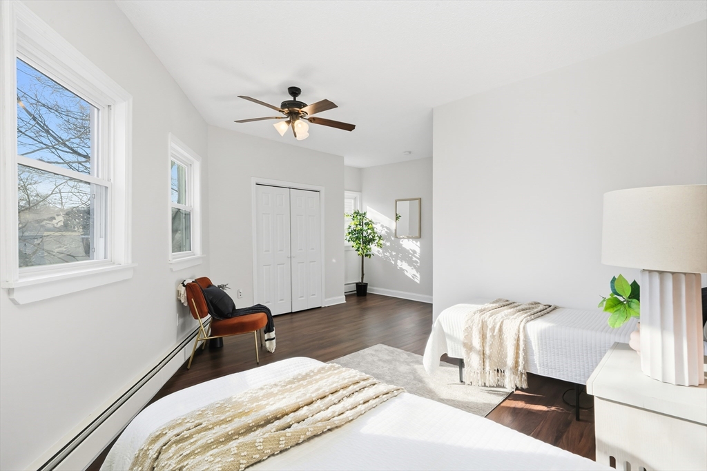 8 Humboldt Avenue, Unit 2 Boston, MA 02119 - Photo 16 of 39 a bedroom with a bed and wooden floor