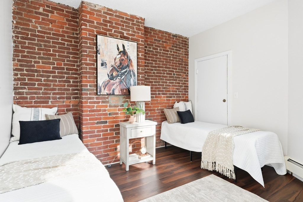 8 Humboldt Avenue, Unit 2 Boston, MA 02119 - Photo 17 of 39 a bedroom with a bed and wooden floor