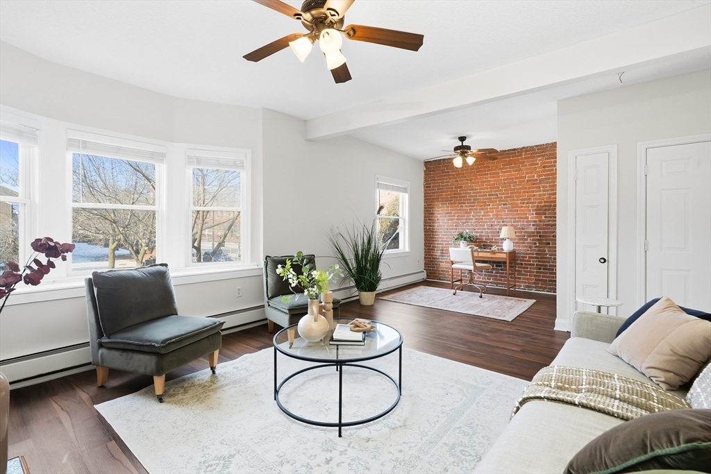 8 Humboldt Avenue, Unit 2 Boston, MA 02119 - Photo 25 of 39 a living room with furniture and wooden floor