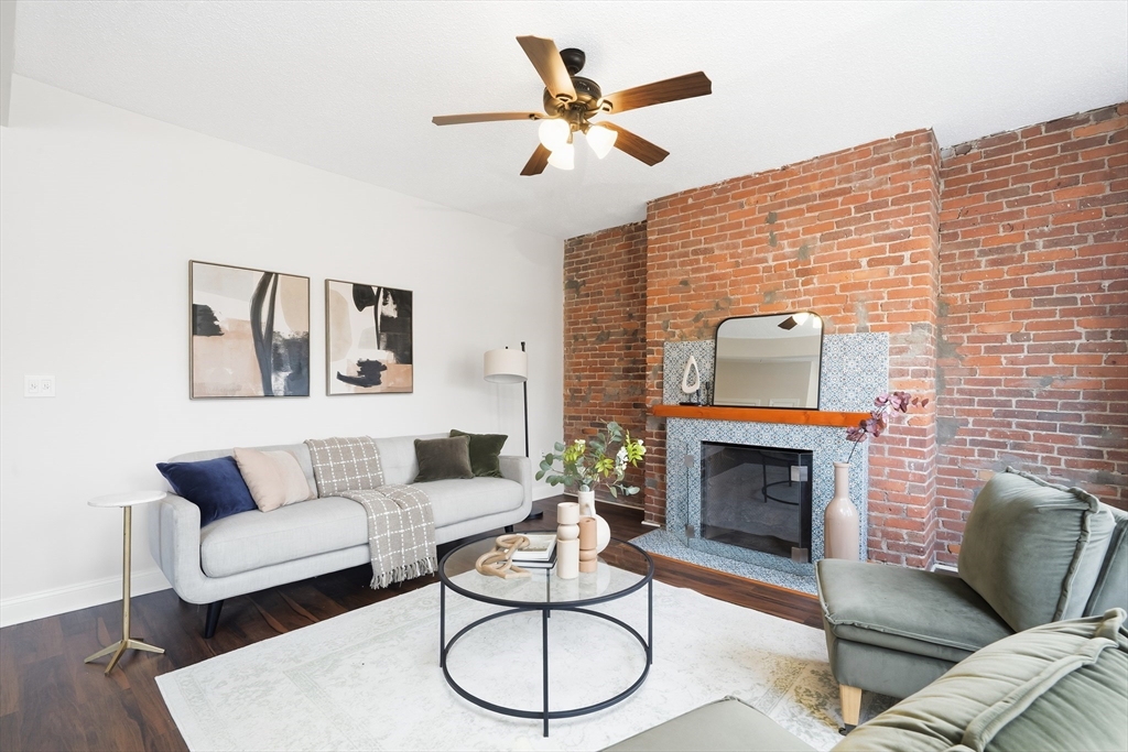 8 Humboldt Avenue, Unit 2 Boston, MA 02119 - Photo 4 of 39 a living room with furniture a rug and a fireplace