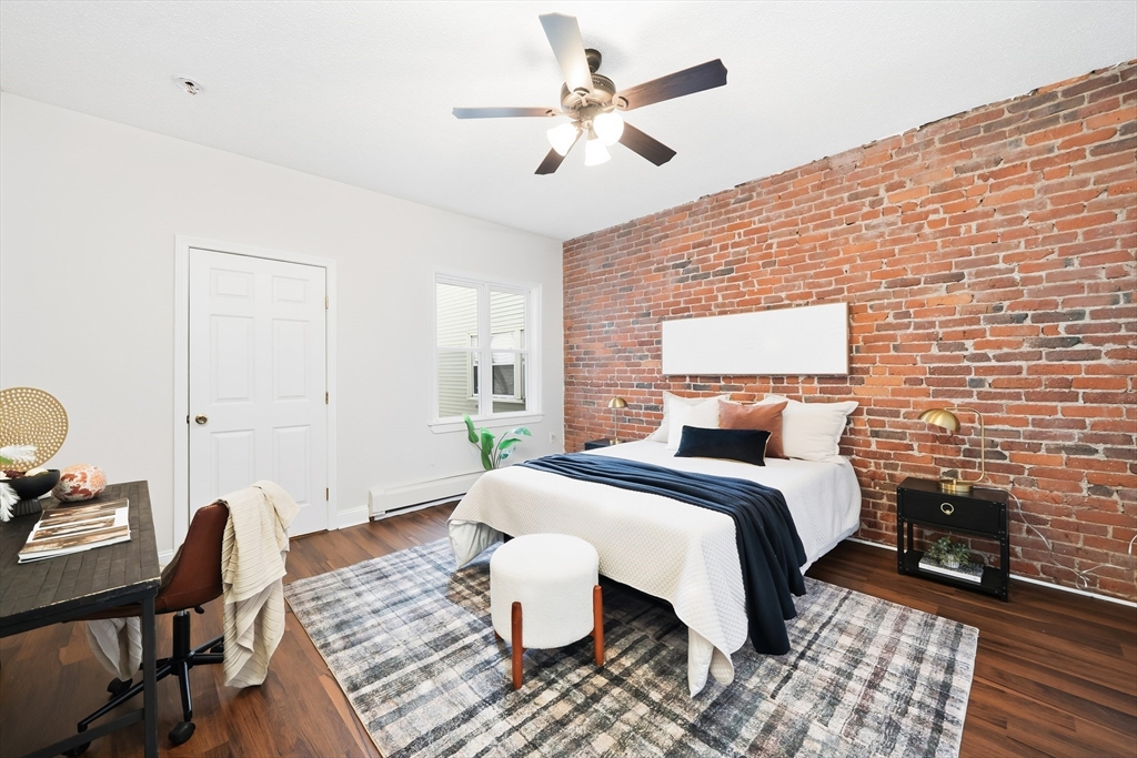 8 Humboldt Avenue, Unit 2 Boston, MA 02119 - Photo 6 of 39 a bedroom with a bed and wooden floor