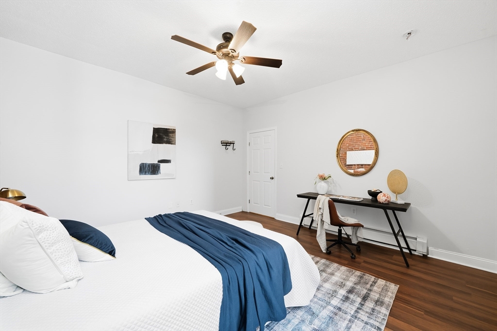 8 Humboldt Avenue, Unit 2 Boston, MA 02119 - Photo 8 of 39 a bedroom with a bed and a chandelier