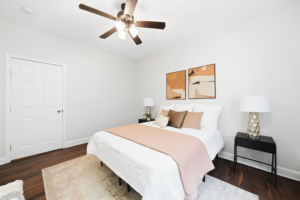 8 Humboldt Avenue, Unit 2 Boston, MA 02119 - Photo 10 of 39 a bedroom with a bed and a chandelier