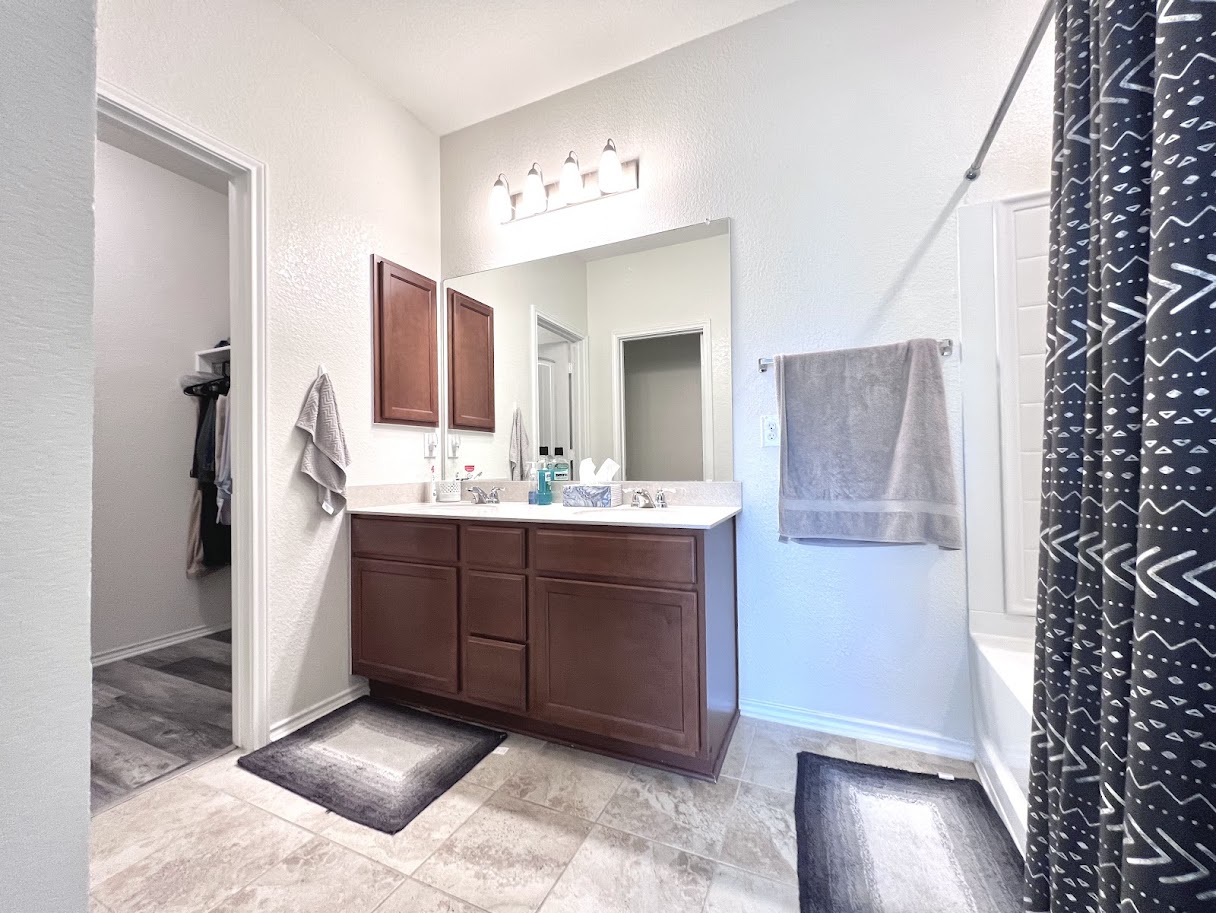 7900 Crystalbrook West Austin, TX 78724 - Photo 24 of 27 a bathroom with a sink vanity and a mirror