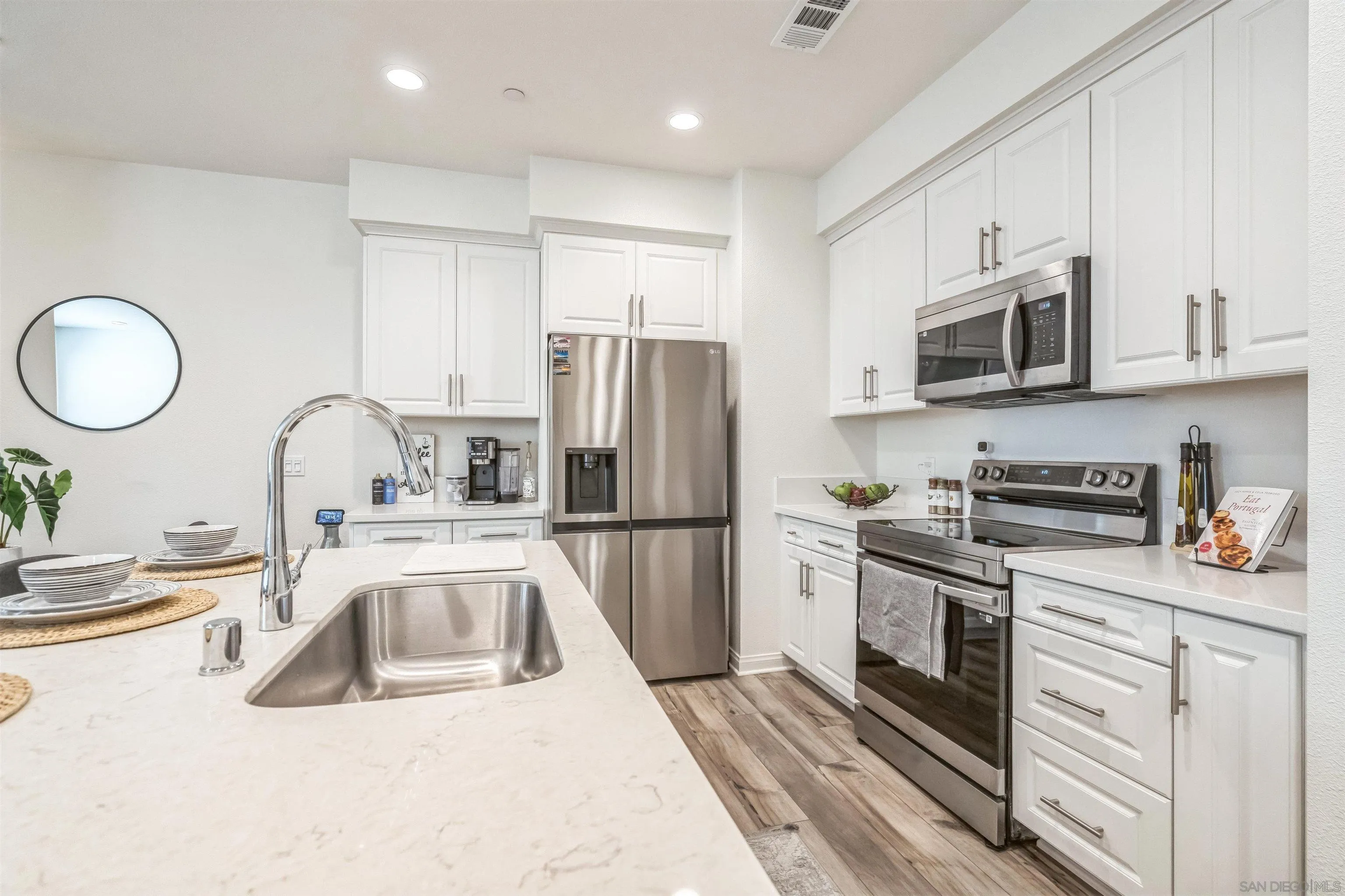 2018 Barite Street Spring Valley, CA 91977 - Photo 9 of 47 a kitchen with a sink stove and refrigerator