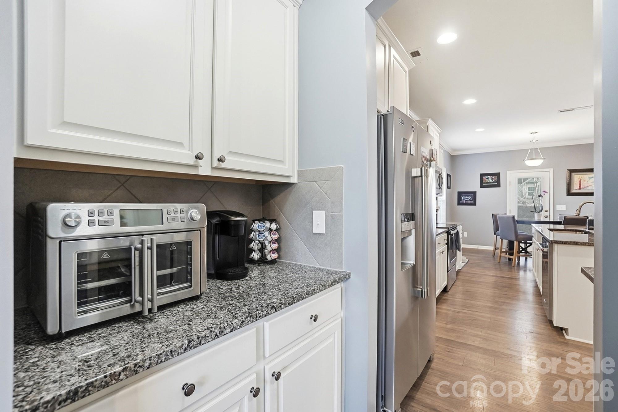 1103 Clover Lane Matthews, NC 28104 - Photo 16 of 46 a kitchen with stainless steel appliances granite countertop a stove a sink and a microwave