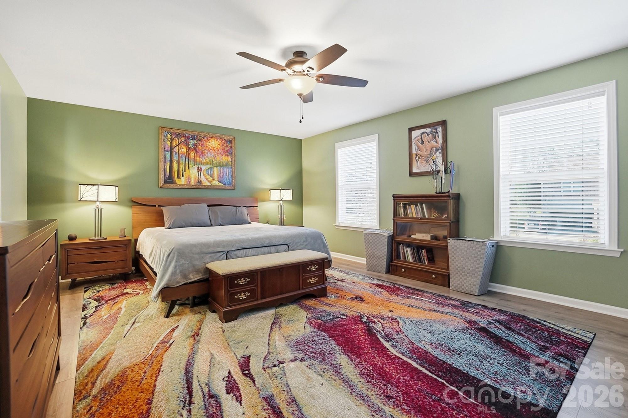 1103 Clover Lane Matthews, NC 28104 - Photo 27 of 46 a bedroom with a bed and dresser with wooden floor