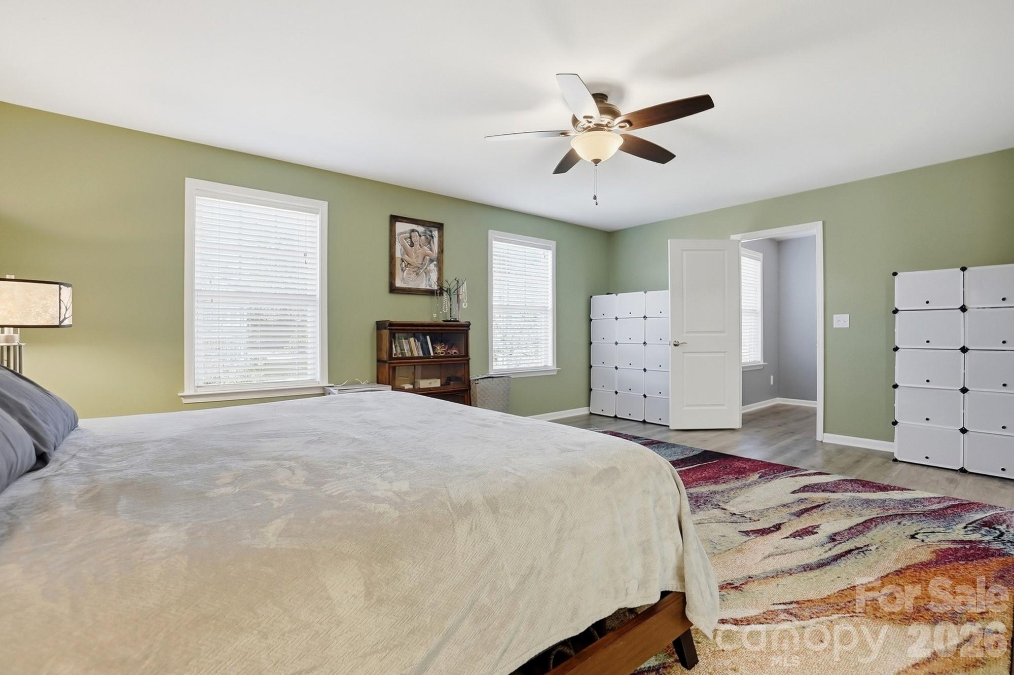 1103 Clover Lane Matthews, NC 28104 - Photo 28 of 46 a bedroom with a large bed and a chandelier