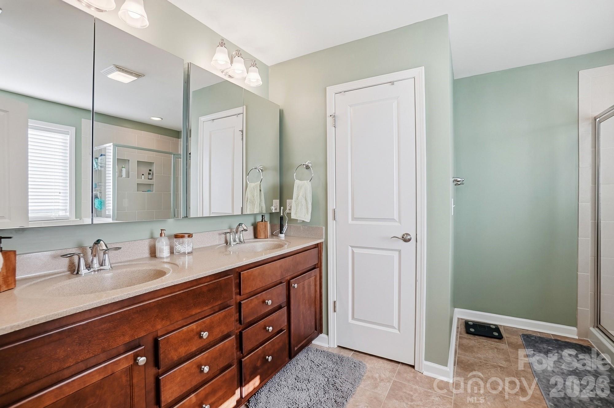 1103 Clover Lane Matthews, NC 28104 - Photo 29 of 46 a bathroom with a double vanity sink and mirror