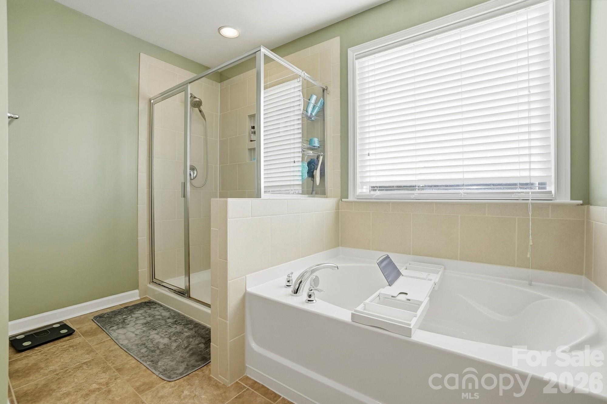 1103 Clover Lane Matthews, NC 28104 - Photo 30 of 46 a bathroom with a bathtub and a shower