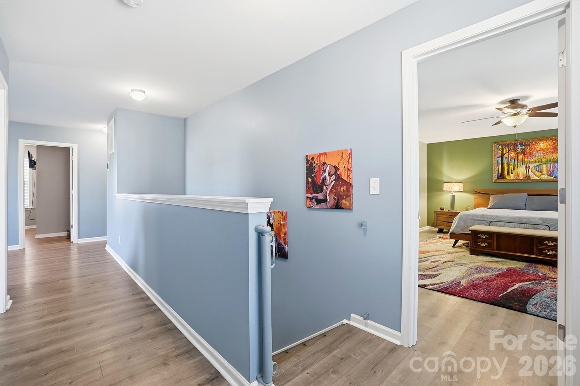 1103 Clover Lane Matthews, NC 28104 - Photo 33 of 46 a view of a hallway with a bedroom and wooden floor