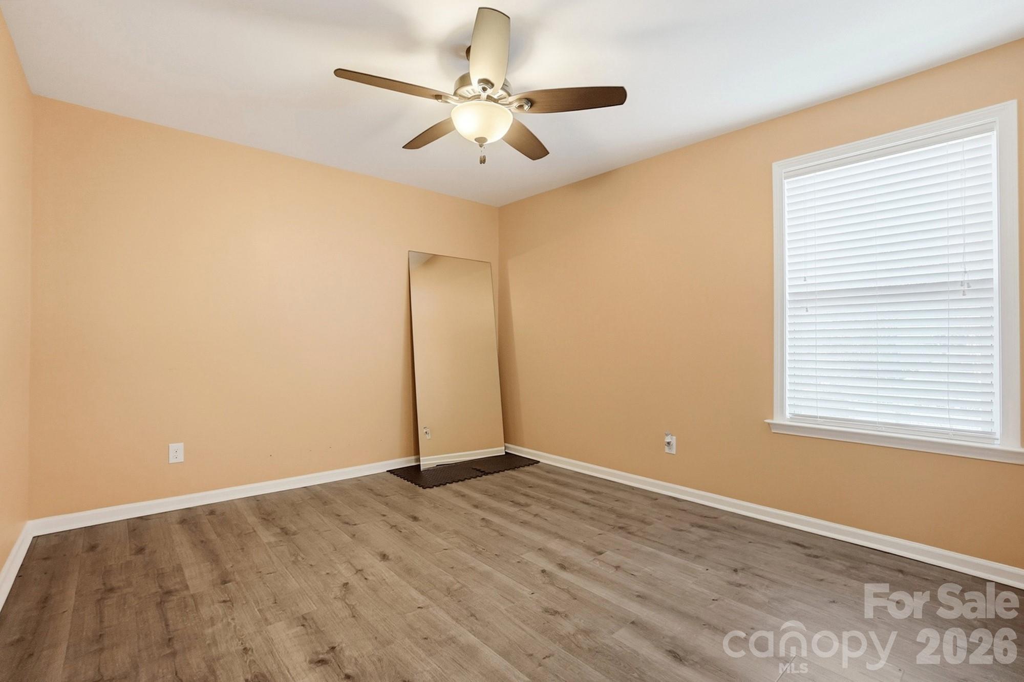 1103 Clover Lane Matthews, NC 28104 - Photo 36 of 46 an empty room with a window and a ceiling fan