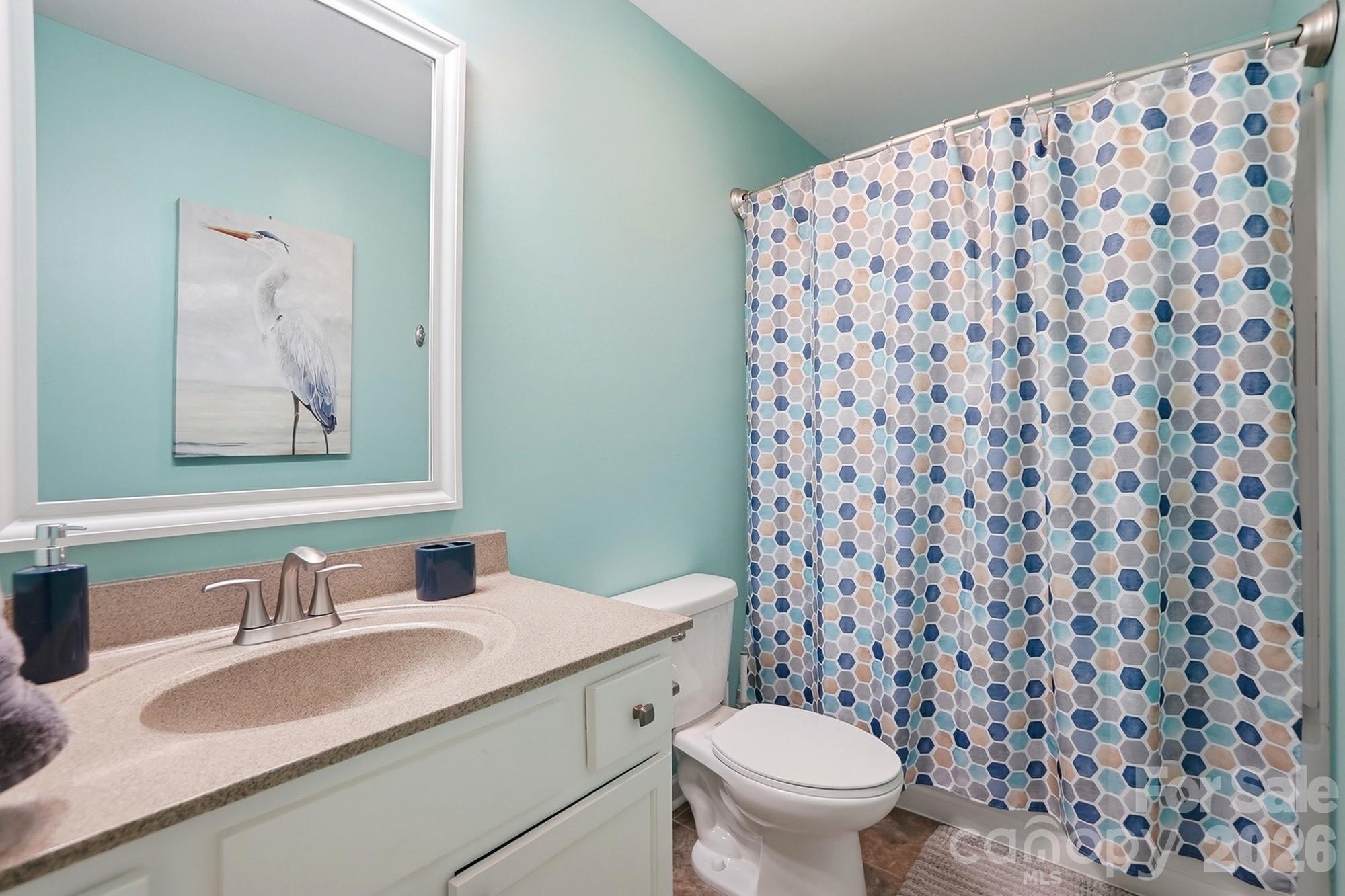 1103 Clover Lane Matthews, NC 28104 - Photo 38 of 46 a bathroom with a granite countertop sink a toilet and a mirror
