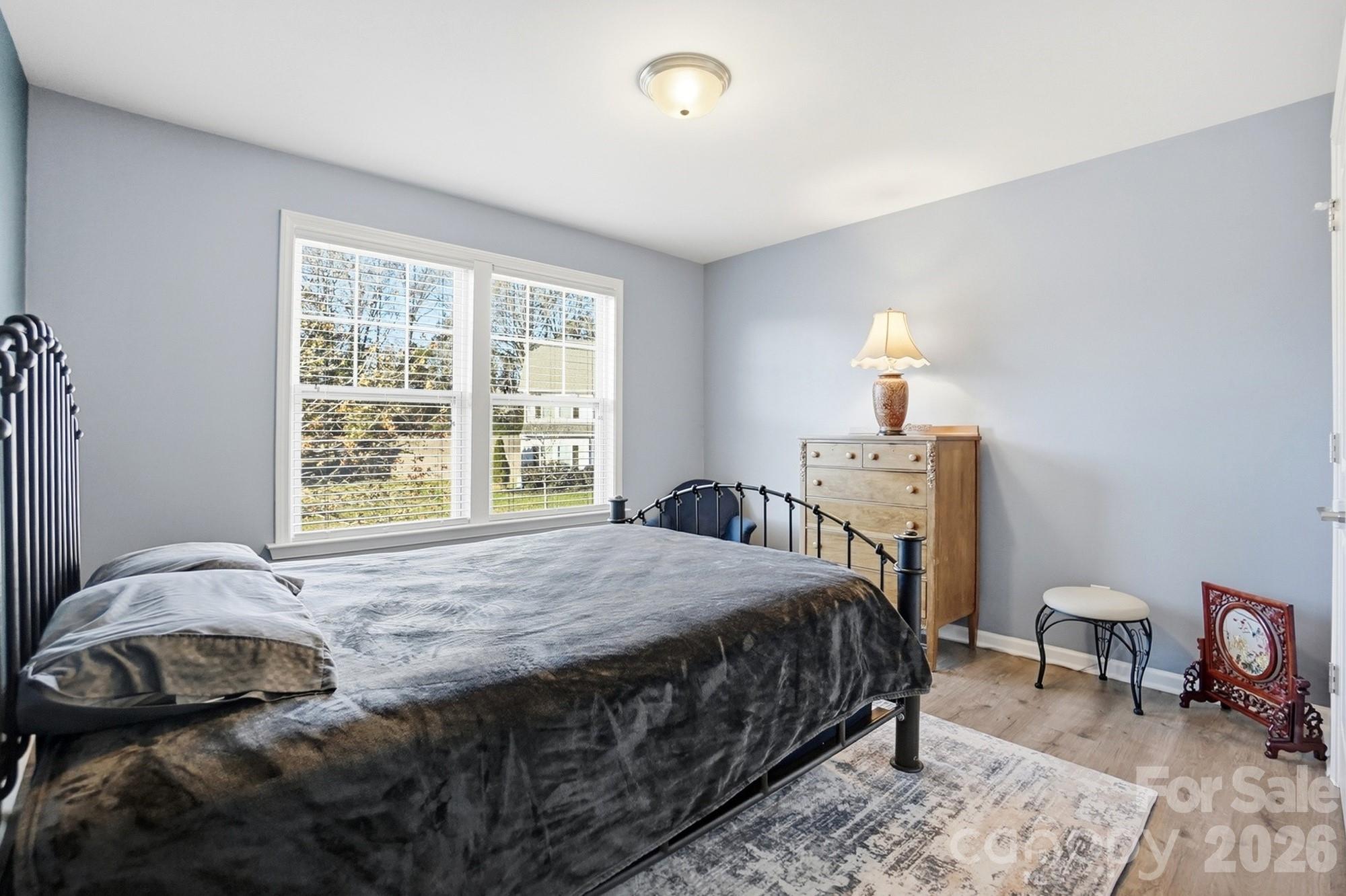 1103 Clover Lane Matthews, NC 28104 - Photo 42 of 46 a bedroom with a bed a table and chair
