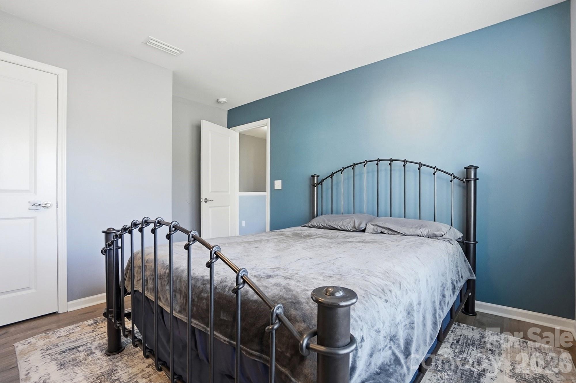 1103 Clover Lane Matthews, NC 28104 - Photo 43 of 46 a bedroom with a bed and wooden floor