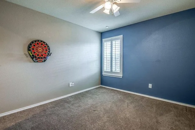 an empty room with a fan