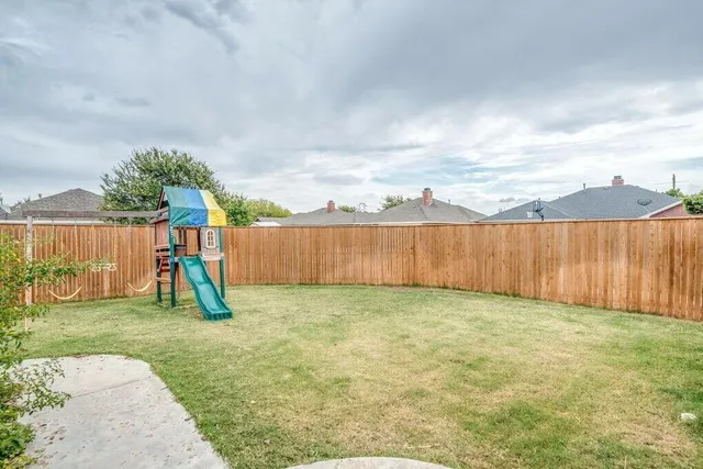 a view of a backyard with a trampoline