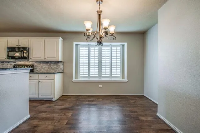 a view of a kitchen with a sink cabinets and wooden floor