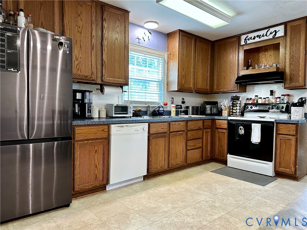 7817 Woodbrook Road Quinton, VA 23141 - Photo 7 of 28 Kitchen featuring abundant wood cabinetry, white d