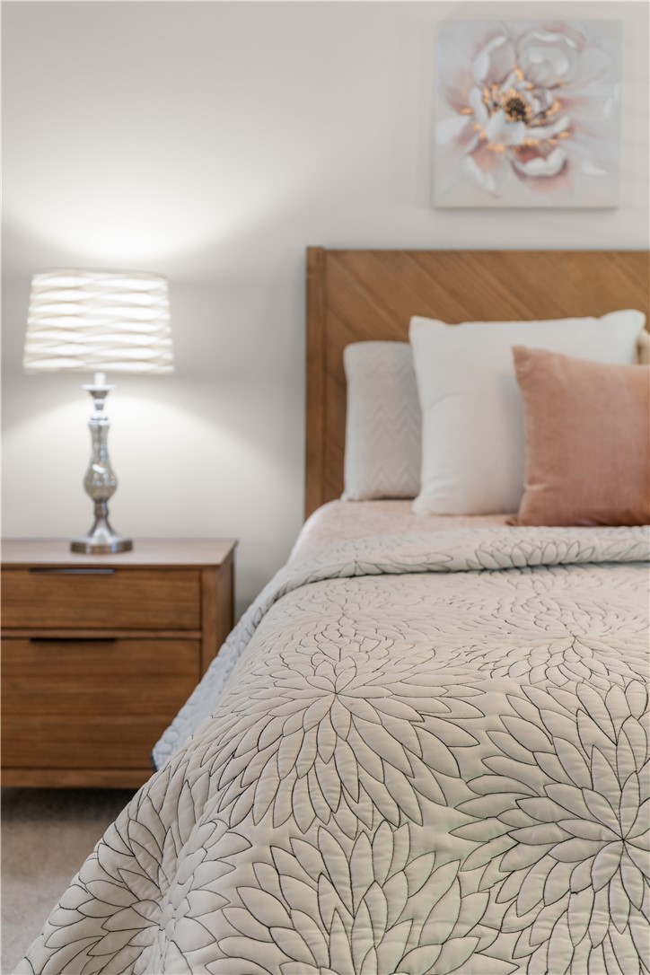 312 English Oak Road Simpsonville, SC 29681 - Photo 28 of 48 This cozy bedroom features warm lighting and elegant wood details, creating a serene personal retreat.