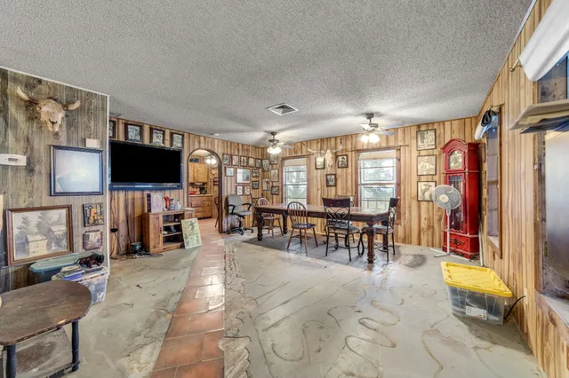 a living room with lots of furniture and a flat screen tv