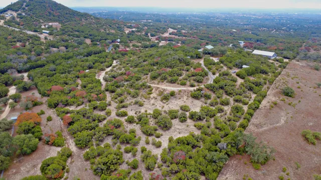 an aerial view of a houses with a yard