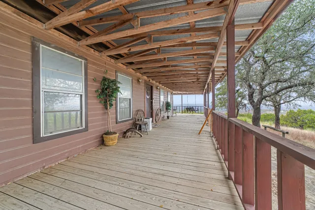 a view of outdoor space with wooden deck and furniture
