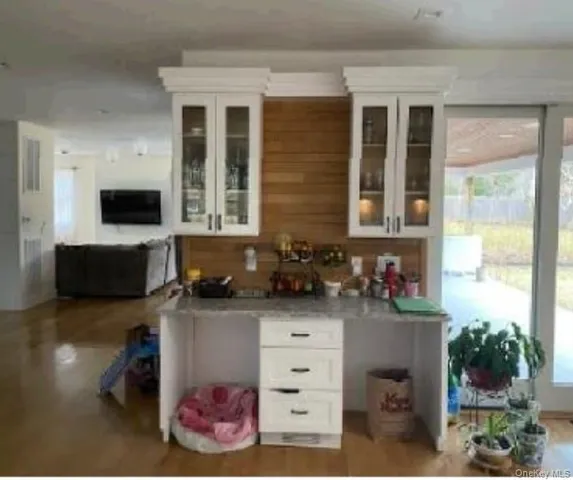 a kitchen with stainless steel appliances kitchen island granite countertop a sink a counter top space and cabinets