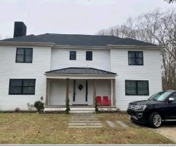 a view of kitchen with cabinets dining table and chairs