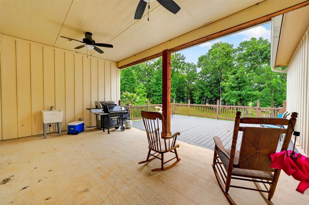 5230 Esquire Estates Road Mabank, TX 75156 - Photo 33 of 39 Spacious covered patio area featuring a concrete floor, two ceiling fans, and a utility sink