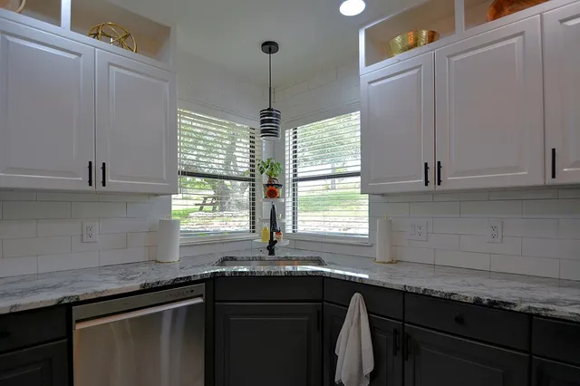 a bedroom with a bed couch and a chandelier