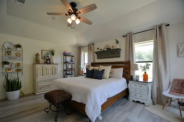a bedroom with furniture and flat screen tv