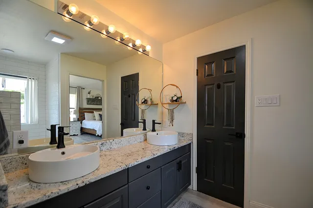 a bedroom with a bed and a large window